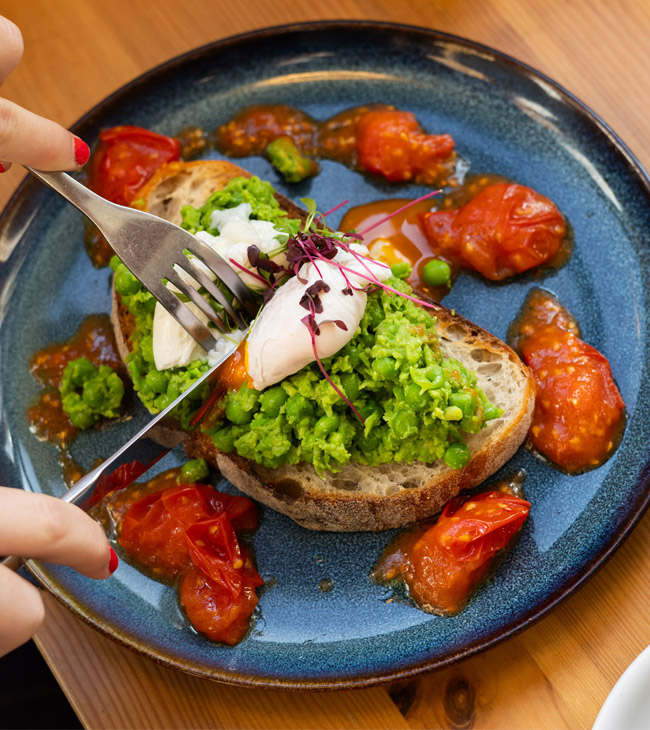 Poached eggs and avocado on sourdough toast served for breakfast at the Lodge at Lulworth.